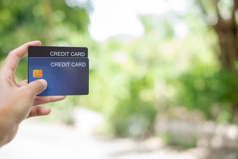 credit-card-hand-holding-credit-card-with-green-n-2023-11-27-05-29-19-utc